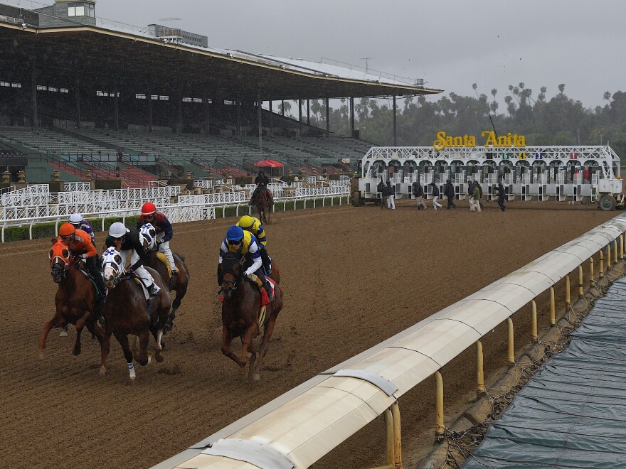 Horses run in the fourth race at Santa Anita Park in front of empty stands, Saturday, March 14 in Arcadia, Calif. Racing at the facility has been suspended since March 27 because of the coronavirus.