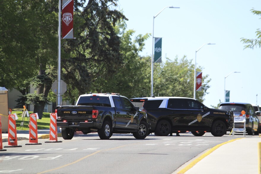 Authorities block access to an area on the University of New Mexico campus where two people were shot, one fatally, in the early morning hours in Albuquerque, N.M., on Friday, July 25, 2025. (AP Photo/Susan Montoya Bryan)