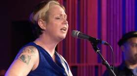 Daphne Parker Powell singing and playing guitar