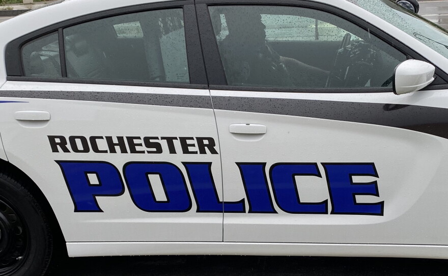 A police officer inside a Rochester police cruiser.