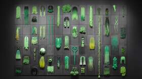 Tiff Massey's installation I've Got Bundles And I Got Flewed Out (Green) is comprised of canvas, Kanekelon, and beads.