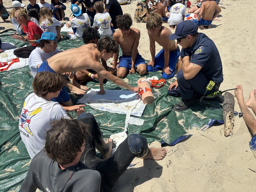 Kids in a junior lifeguard program learn some basic trauma care techniques as a part of the the international Stop The Bleed program. The program teaches people how to apply a tourniquet, and plug open, bleeding wounds.
