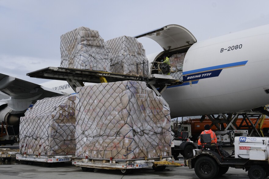 Ground crew at Los Angeles International Airport unload pallets of supplies of personal protective equipment from a China Southern Cargo plane upon its arrival on April 10.