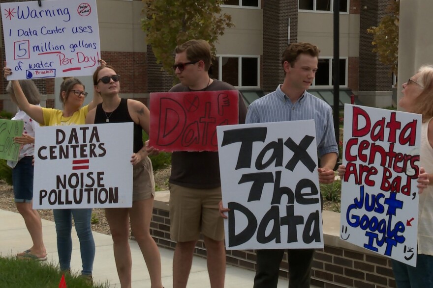 Protesters gather with signs