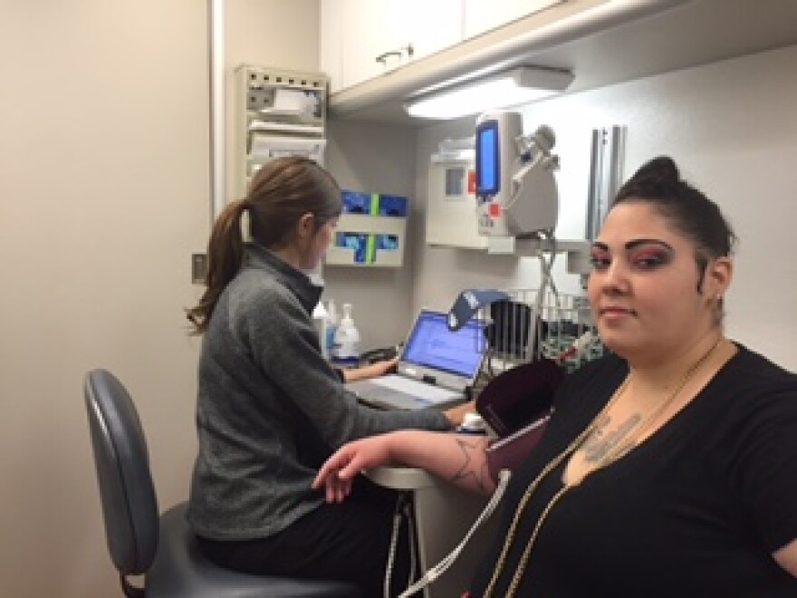 Hannah Salam gets checked on the mobile health van by nurse Cori Dickie.