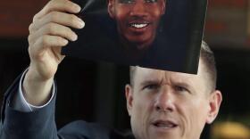 Attorney Bobby DiCello holds up a photograph of Jayland Walker during a news conference July 3, 2022, in Akron, Ohio.