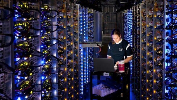 This photo provided by Google shows a Google technician working on some of the computers inside a data center.