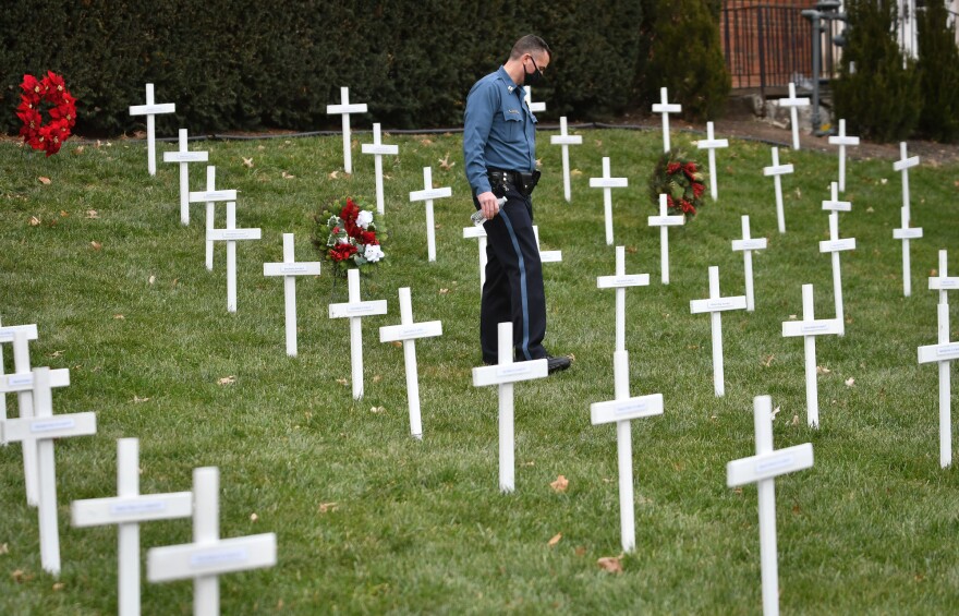 Kansas City police officer Dave Jackson walks among the 173 crosses staked in front of Wornall Road Baptist Church on Friday following a press conference announcing plans for the Longest Night remembrance of homicide victims in Kansas City.