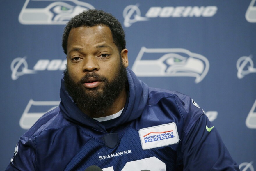 Seattle Seahawks defensive end Michael Bennett talks to reporters, Tuesday, Jan. 10, 2017, in Renton, Wash. The Seahawks will play the Atlanta Falcons in an NFL football NFC playoff game, Saturday, Jan. 14, 2017 in Atlanta (AP Photo/Ted S. Warren)