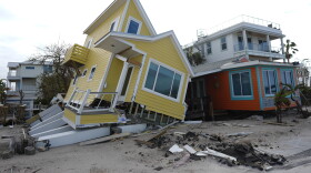 FILE - A house lies toppled off its stilts after the passage of Hurricane Milton, in Bradenton Beach on Anna Maria Island, Fla., Oct. 10, 2024.