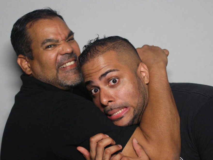 Abraham Guzman (left) puts John Torres Jr. in a friendly chokehold at the StoryCorps booth in New York City.