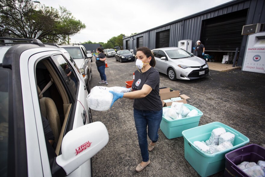 Holly McDaniel with Austin Diaper Bank distributes free diapers to families March 27.