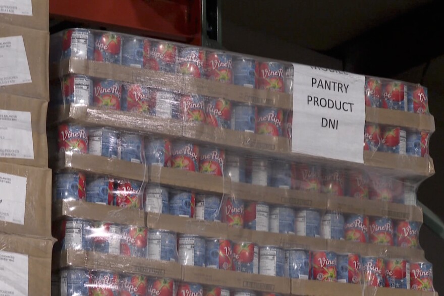 Cans of tomatoes are stacked in the warehouse at the Hoosier Hills Food Bank.