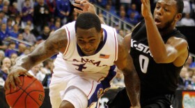 Kansas guard Sherron Collins (4) drives past Kansas State guard Jacob Pullen during the first half of an NCAA college basketball game at the Big 12 tournament Saturday in Kansas City, Mo.