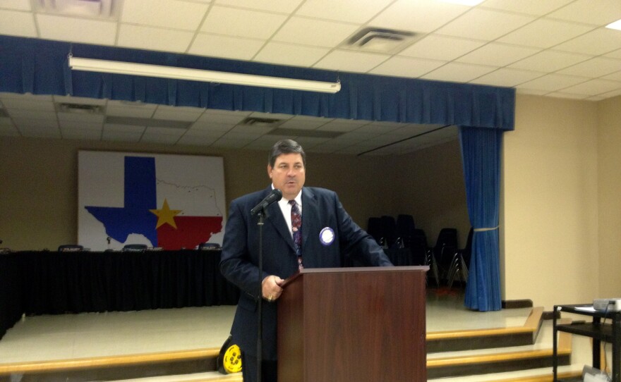 Former Commerce ISD Superintendent Blake Cooper addresses attendees at the CISD administration building.