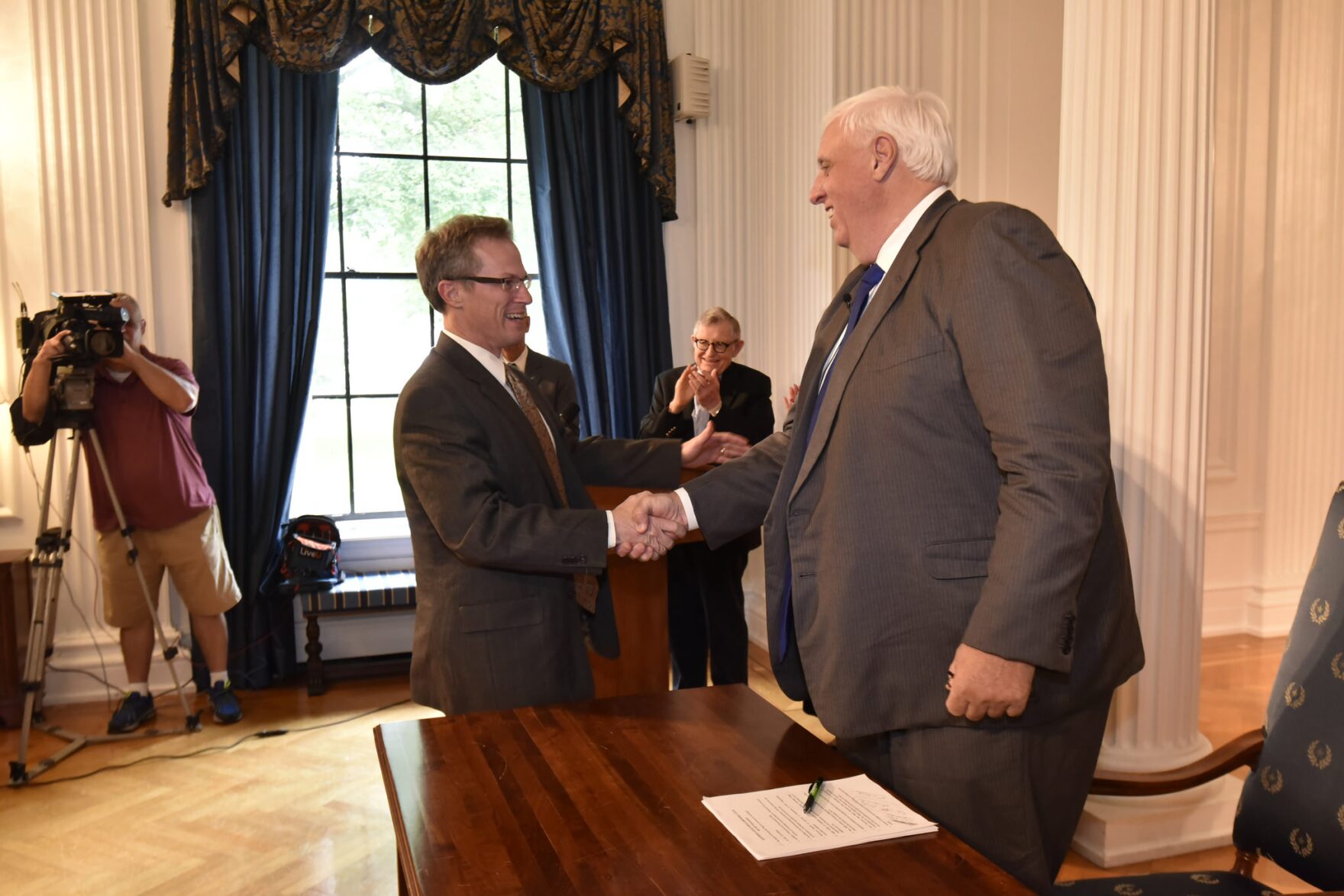 Daniel W. Greear shakes hands with Gov. Jim Justice during a press conference on July 2, 2018.