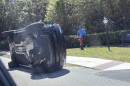 Golfer Tiger Woods stands by his overturned vehicle in Jupiter Island, Fla., on Friday, March 27, 2026.