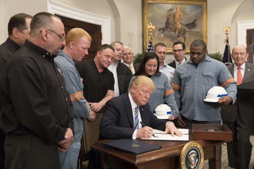 President Donald Trump signs a proclamation on steel and aluminum imports.