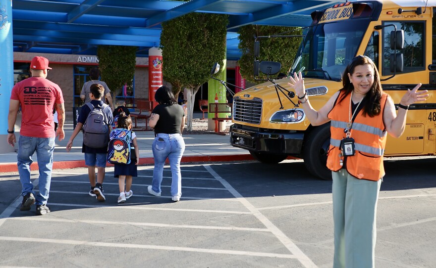 Outside the school, this crossing guard welcomed families and students to Ronald Reagan while keeping the street clear.