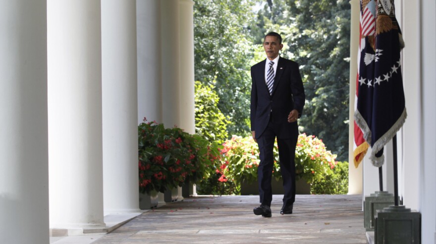 President Obama walks to the Rose Garden of the White House to discuss the debt-ceiling bill passed by the Senate.