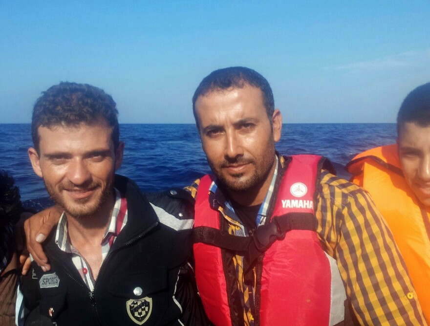 Omar (center) and Alhees (left) traveled by raft from Izmir, Turkey, to Lesbos, Greece.