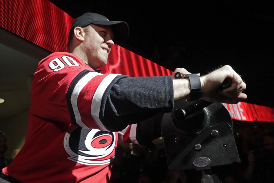 Dave Ayres sounds the siren before an NHL hockey game between the Carolina Hurricanes and the Dallas Stars in Raleigh, N.C., on Tuesday, Feb. 25, 2020.