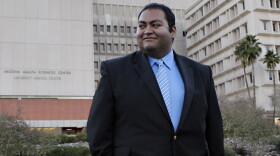 Daniel Hernandez walks across the lawn outside University Hospital in Tucson on Sunday. Prior to his current internship he worked on Rep. Gabrielle Giffords' 2008 campaign.
