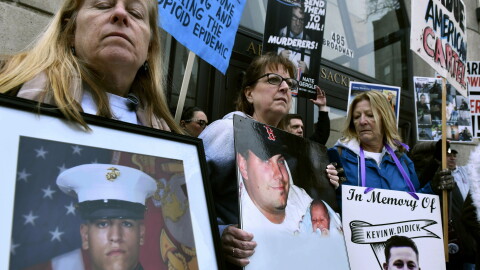 Kathleen Scarpone, left, of Kingston, N.H., and Cheryl Juaire, second from left, of Marlborough, Mass., protest in front of the Arthur M. Sackler Museum, at Harvard University, April 12, 2019, in Cambridge, Mass. Scarpone, who lost her son to OxyContin addiction, and Juarie addressed three Sackler family members during a virtual U.S. Bankruptcy Court hearing, Thursday, March 10, 2022. (AP Photo/Josh Reynolds, File)