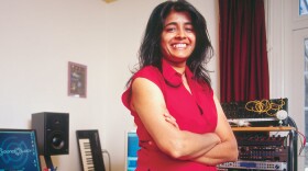 Gaming and film composer Nainita Desai in studio wearing jeans and red shirt
