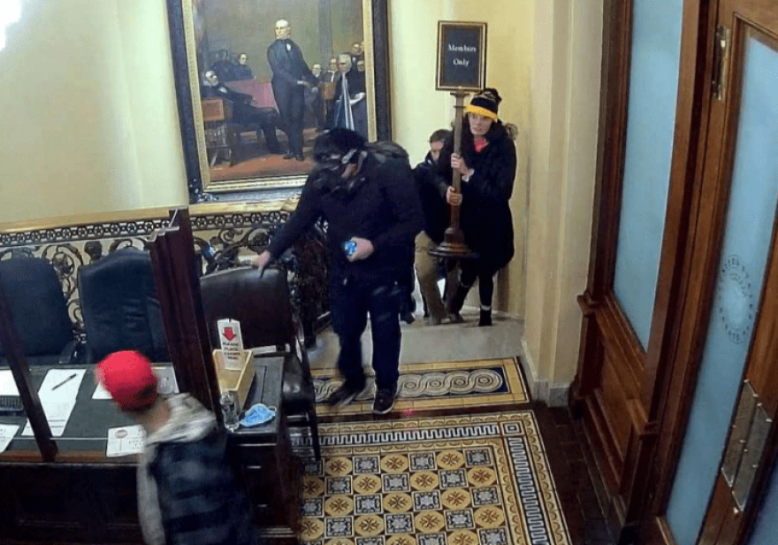 Surveillance footage showing Courtright carrying a “member’s only” sign to the second floor of the U.S. Capitol on Jan. 6.