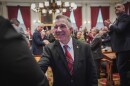 Republican Gov. Phil Scott shakes hands with lawmakers after delivering his budget address at the Montpelier Statehouse on Jan. 20, 2026.