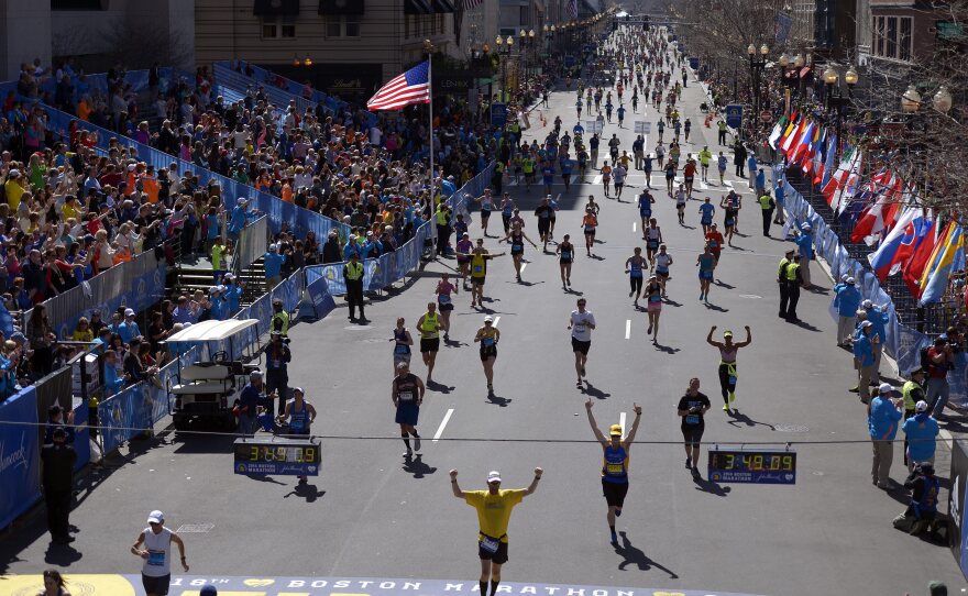Runners approach the finish line during the 118th running of the Boston Marathon on Monday. A number of the world's top runners were in the field amid heavy security one year after a deadly terrorist bombing.