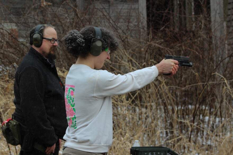 Liberal Gun Club instructor Matt Shepherd (left) watches as Erin Ramsby, a trans woman from Columbus, practices handling a gun in Shelby, Ohio.