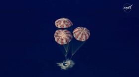In this image from video provided by NASA, the Artemis II Orion capsule splashes down in the Pacific Ocean, on Friday, April 10, 2026. (NASA via AP)