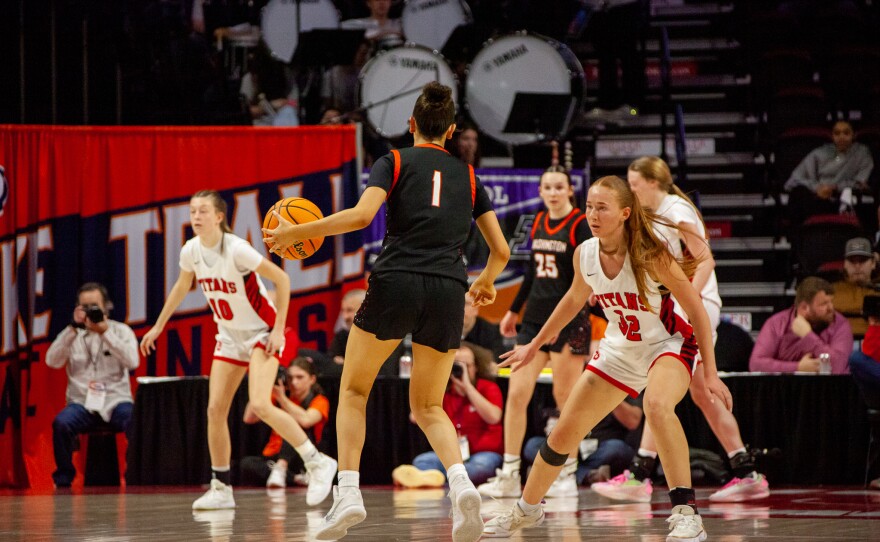 Girls high school basketball players inside an arena