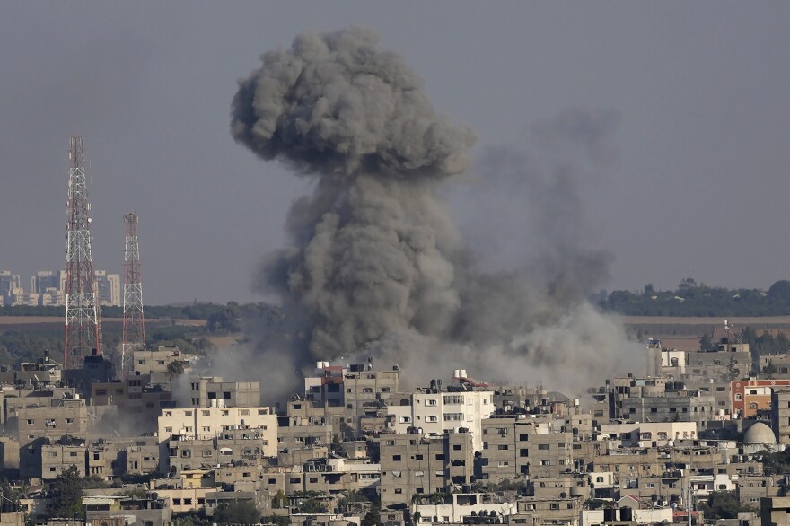 Smoke rises after Israeli airstrikes on a residential building in Gaza, Sunday, Aug. 7.