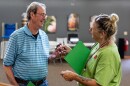 Dave Tanner takes an "I Voted" sticker from election judge Cathy Dietrich at Woodrow Town Hall on Primary Election Day, Aug. 11, 2026.