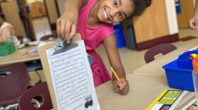 Jamya Mercer shows off her completed Mad Libs assignment.
