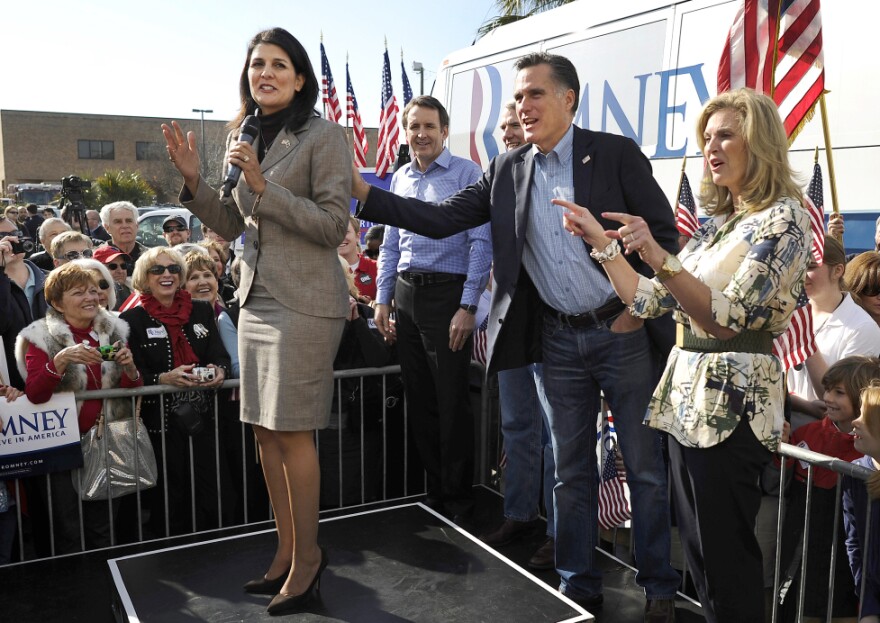 Mitt Romney and his wife, Ann, wish a happy birthday to South Carolina Gov. Nikki Haley (left) at Romney's campaign headquarters in Charleston, S.C., on Thursday.