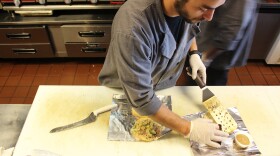 A worker at Moo Cluck Moo, a fast-casual burger and chicken chain in suburban Detroit, prepares a meal. Workers at Moo Cluck Moo all make $15 an hour.