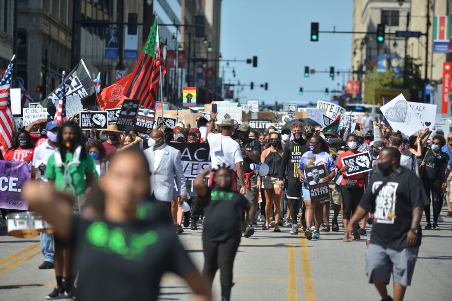 Led by the Broadway Drillteam, protestors fill up Grand Blvd while marching south toward the World War I Museum and Memorial on Friday. 