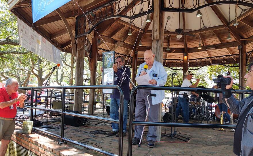 Dr. Norman Vickers, executive director emeritus of Jazz Pensacola, presents a gift to fellow founding member Joe Occhipinti.