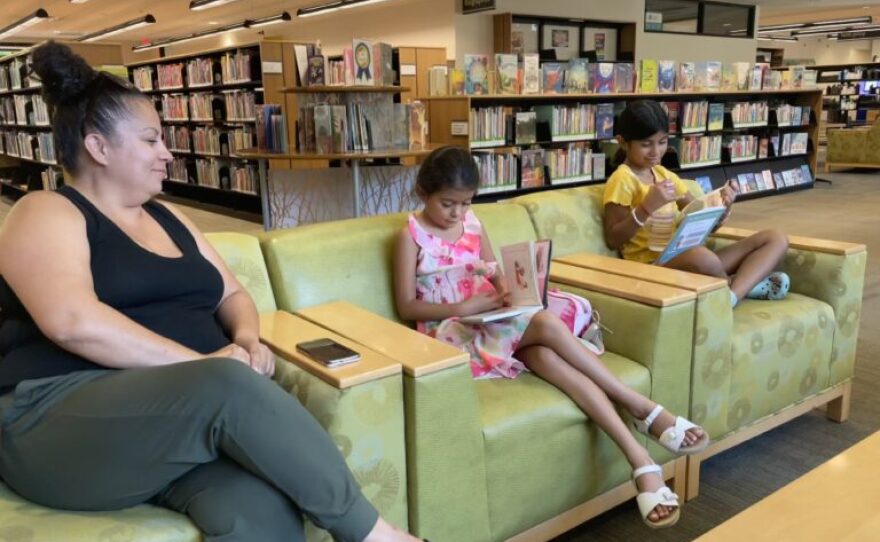 Michelle Diaz, her daughter, and friend at the Gilroy Library.