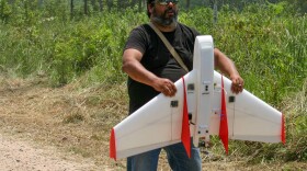 A man and his drone: Carlos Casteneda of the Amazon Basin Conservation Association prepares to launch one of his plastic foam planes.