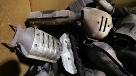 Used catalytic converter that was removed from cars at a salvage yard are piled up in a carton Friday Dec. 17, 2021, in Richmond, Va. Thefts of the emission control devices have jumped over the last two years as prices for the precious metals they contain have skyrocketed. (AP Photo/Steve Helber)