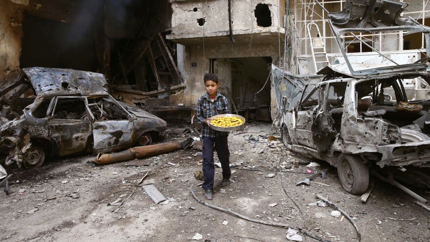 A boy walks through war-torn Douma, Eastern Ghouta, outside of Damascus, Syria, last month. The onetime rebel stronghold is reportedly now under government control.