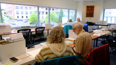 Members of the Alaska State Review Board are seen reviewing precinct ballot counts following the primary election on Aug. 26, 2026.