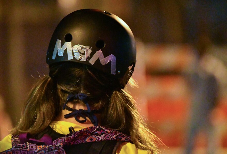 A member of the Wall of Moms Kansas City stands at the fringes of Saturday’s protest in Westport. Saturday was the group’s first event since forming only four days earlier.