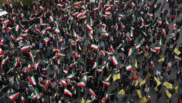 Demonstrators wave Iranian flags in a demonstration in support of the government and against U.S. and Israeli strikes in Tehran, Iran, Saturday, Feb. 28, 2026.