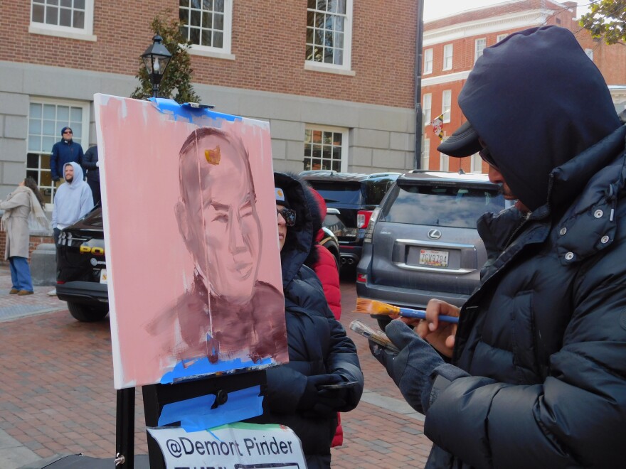 DC-based artist Demont Pinder begins work on a portrait of Paññākāra before the monks' arrival at the
 State House.